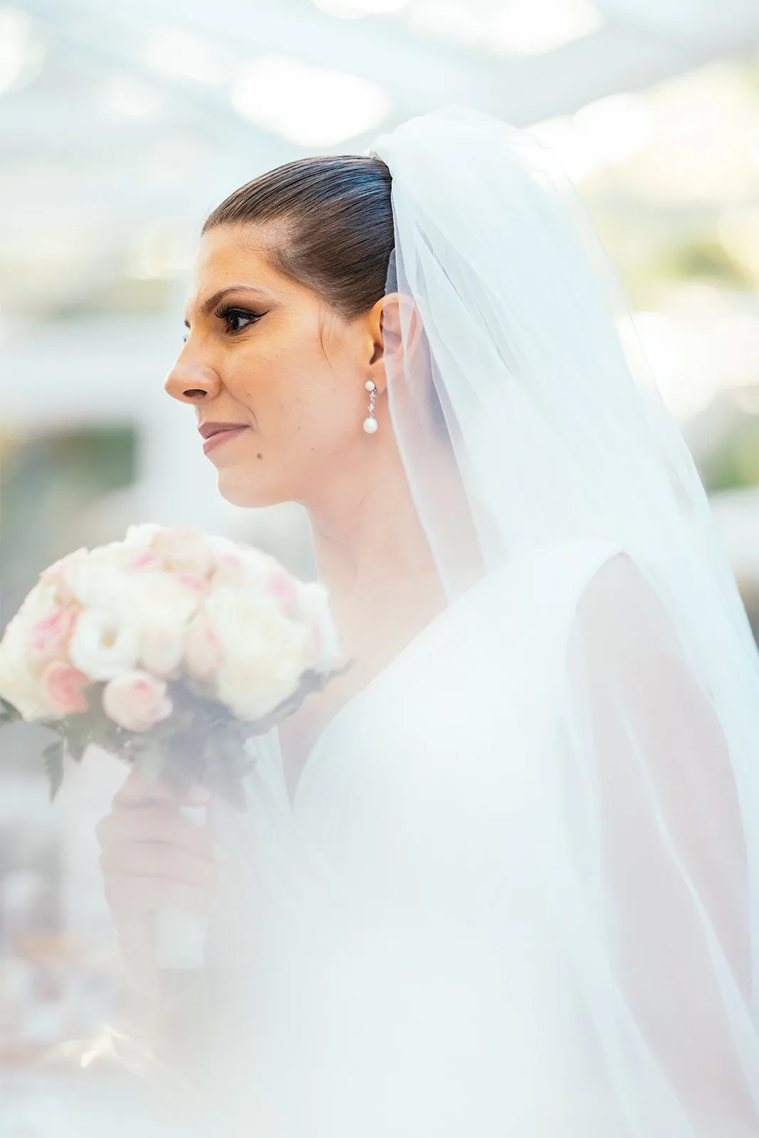 Profil de la mariée sous son voile, en lumière douce