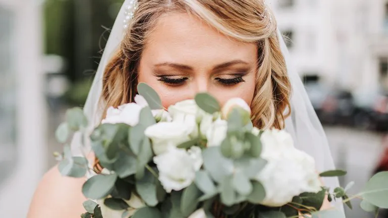 beautiful bride smelling flowers